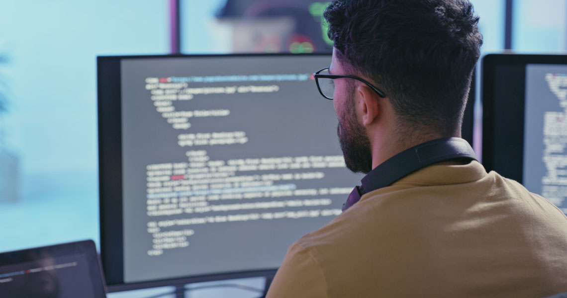 A coder reviewing code on their computer.