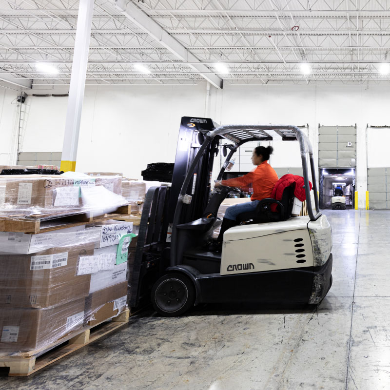 Employee using a forklift.