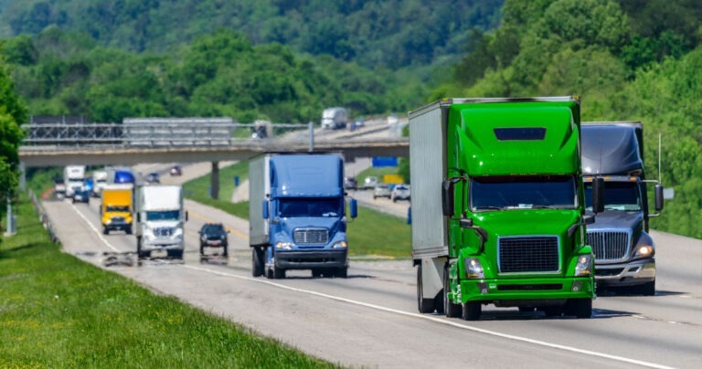 Multiple trucks transporting freight driving down an interstate in Tennessee.