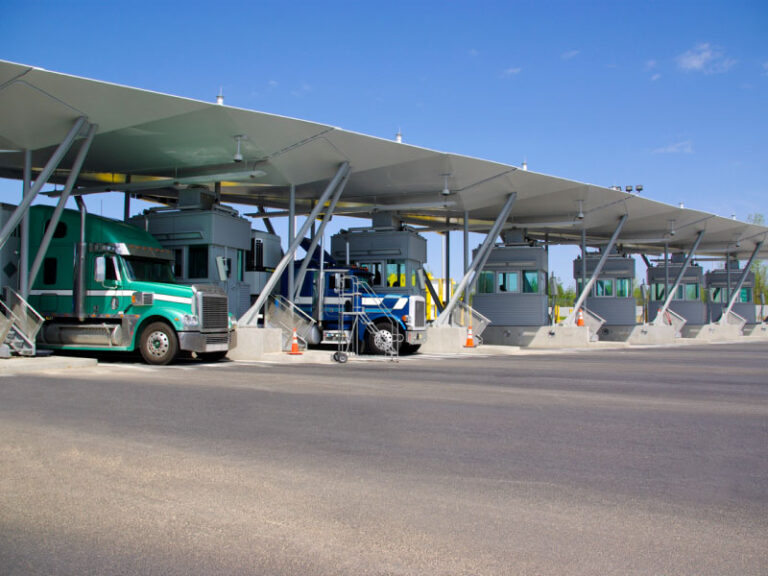 Multiple semi trucks at the Canadian and USA boarder for Canadian customs for cross border shipping.