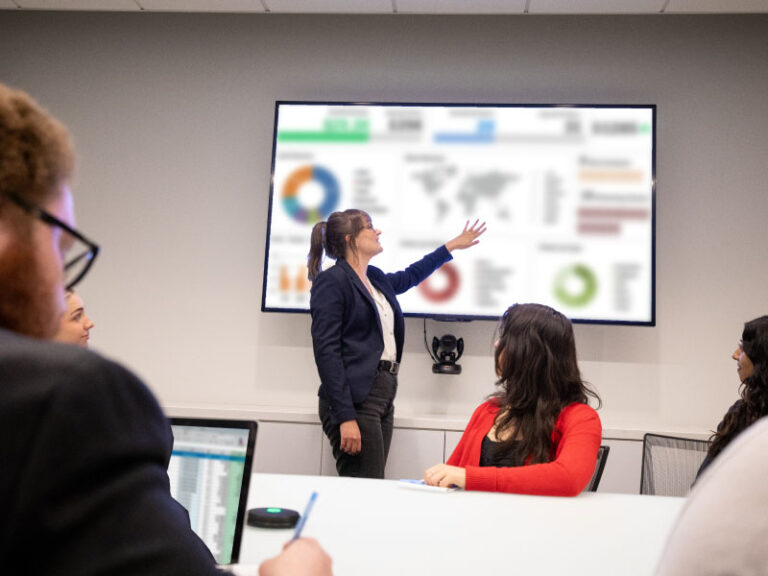 The Echo Managed Transportation team reviewing client metrics in a conference room.