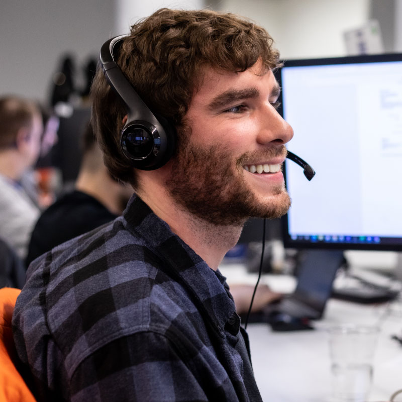 An Echo employee happily helping their client to book their next Partial Truckload shipment.