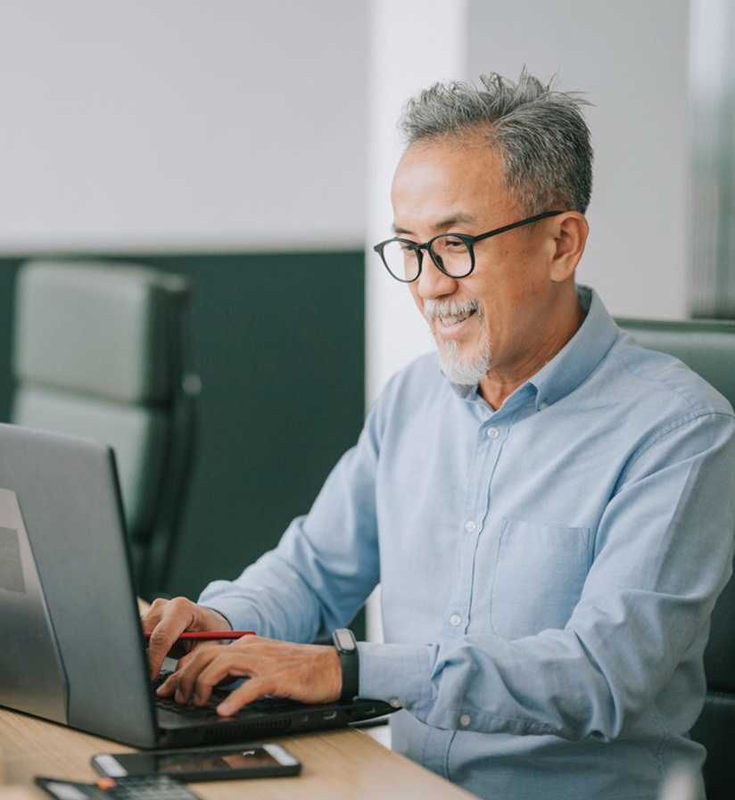 A shipper sitting at a laptop working on shipping their next load.