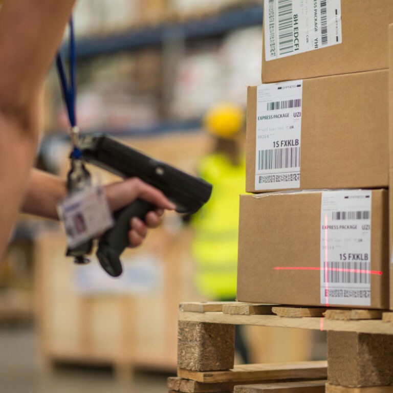 A label scanner checking the label on a small parcel package.