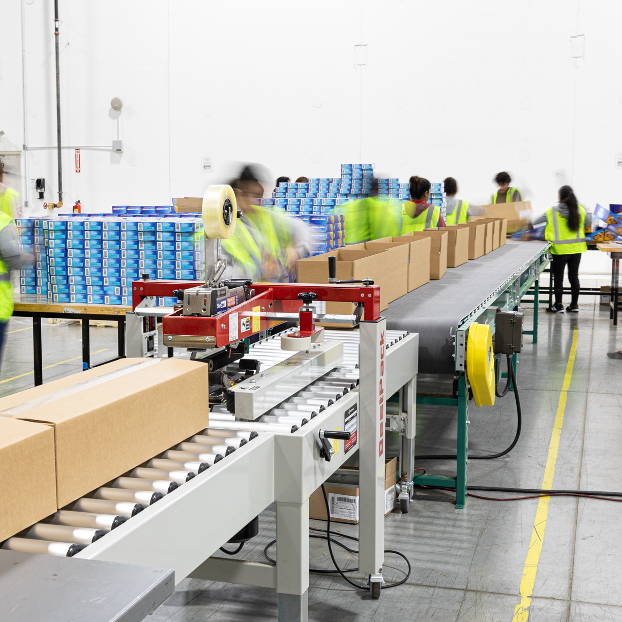 Warehouse workers working in a display building line.