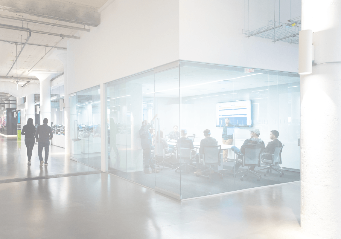 Echo employees having a team meeting in a glass conference room.