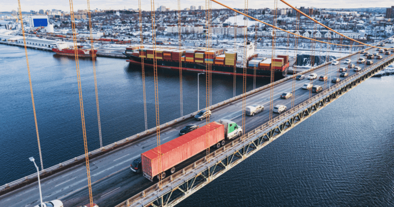 Semi truck driving down bridge.