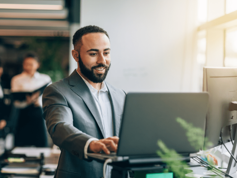 Employee working at standing desk.